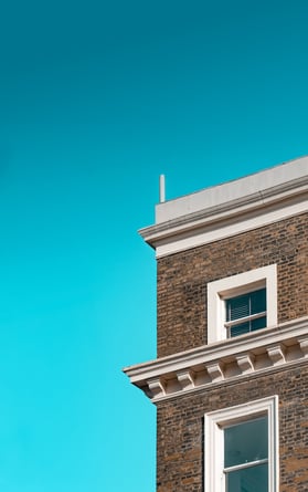 Brown brick building upon a clear teal blue sky