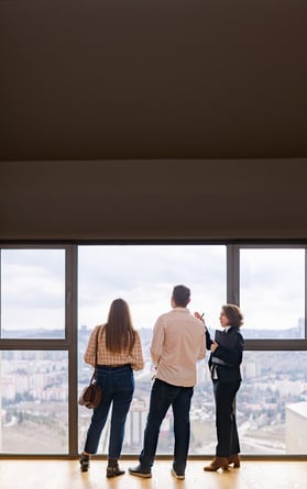Realtor shows couple the view around a potential home.