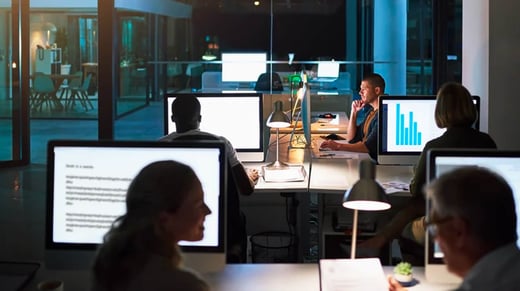 Business people working late in the office at night
