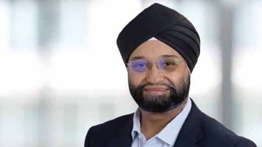 Narinder Auluck in front of a blurred office background