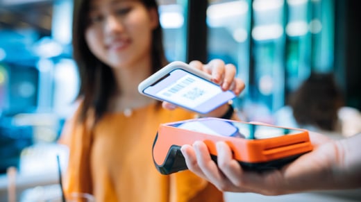 female customer pays for service using mobile phone