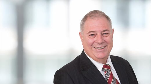 Pepper Advantage Global Head of Operational Fulfilment, Clive Kirkpatrick, in front of a blurred office background.