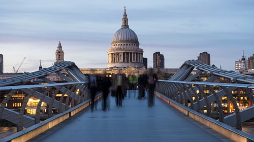 Blurred office workers head home Millennium Bridge, London, UK