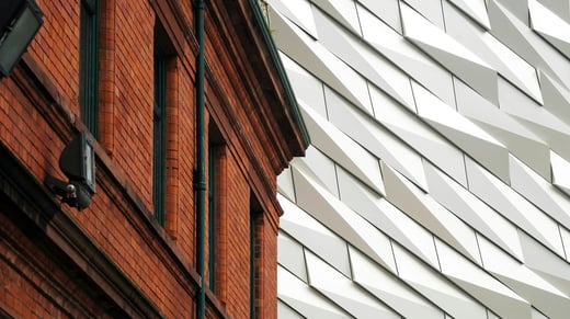 Red brick building beside a modern white office building