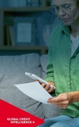 Female looks at her financial expenses with worry.