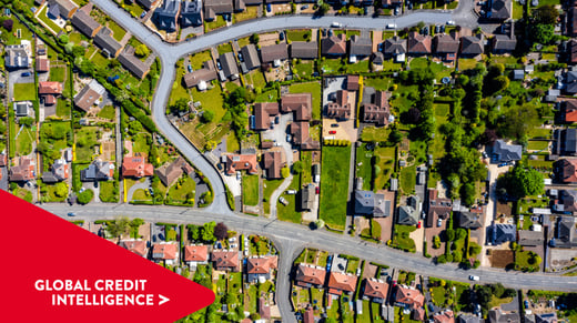 Aerial shot of a residential neighbourhood in the UK. Global Credit Intelligence chevron point overlaid bottom left corner