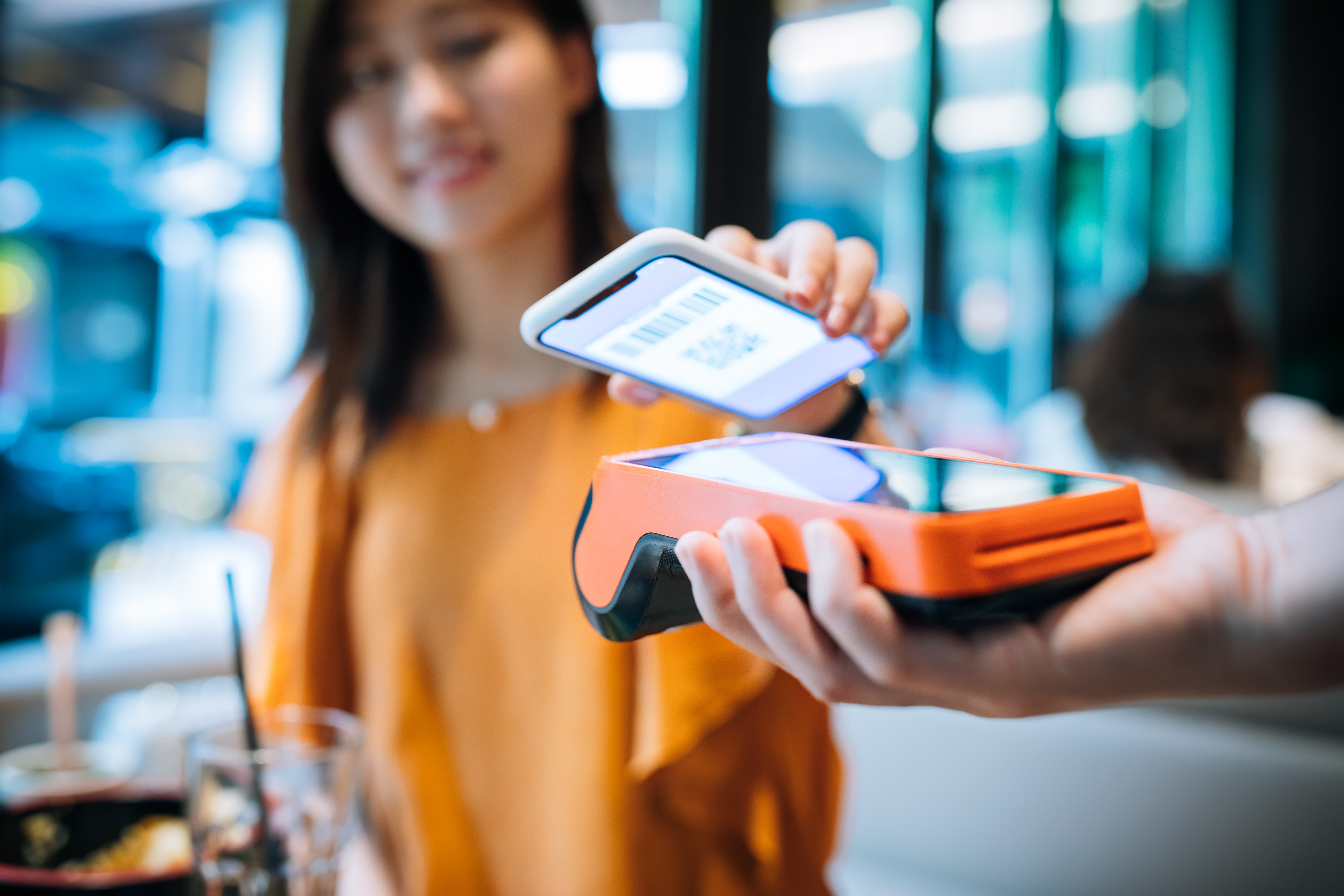 Lady paying for services using her mobile phone