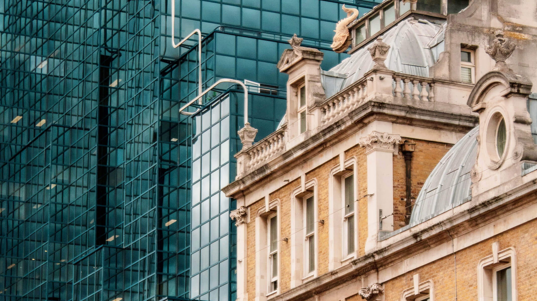 Old and new architecture, Victoria Palace Theatre next to modern office block, London, UK.