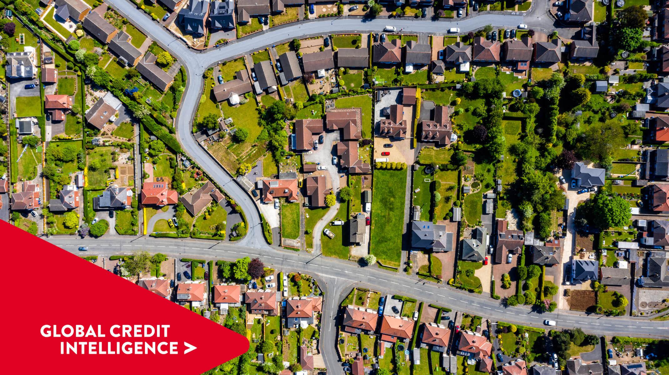 Aerial shot of a residential neighbourhood in the UK. Global Credit Intelligence chevron point overlaid bottom left corner